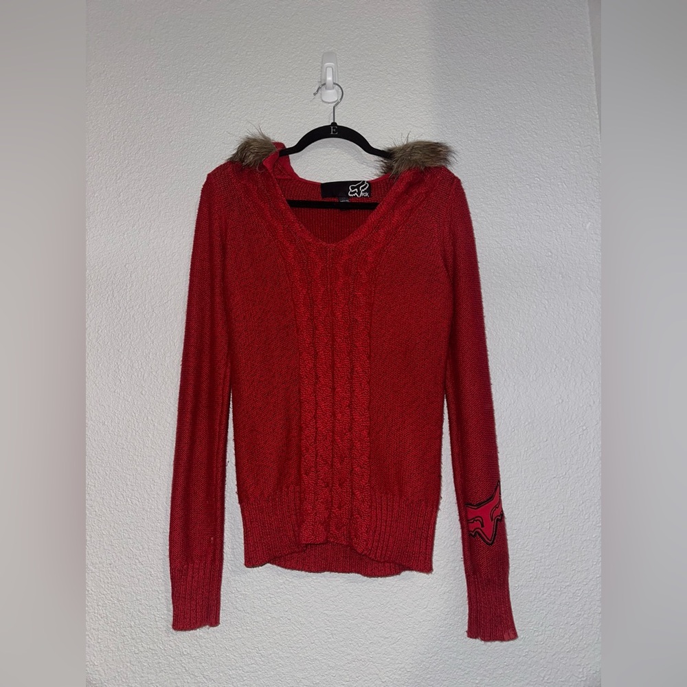 Woman’s fox sweater with fur lined hood.